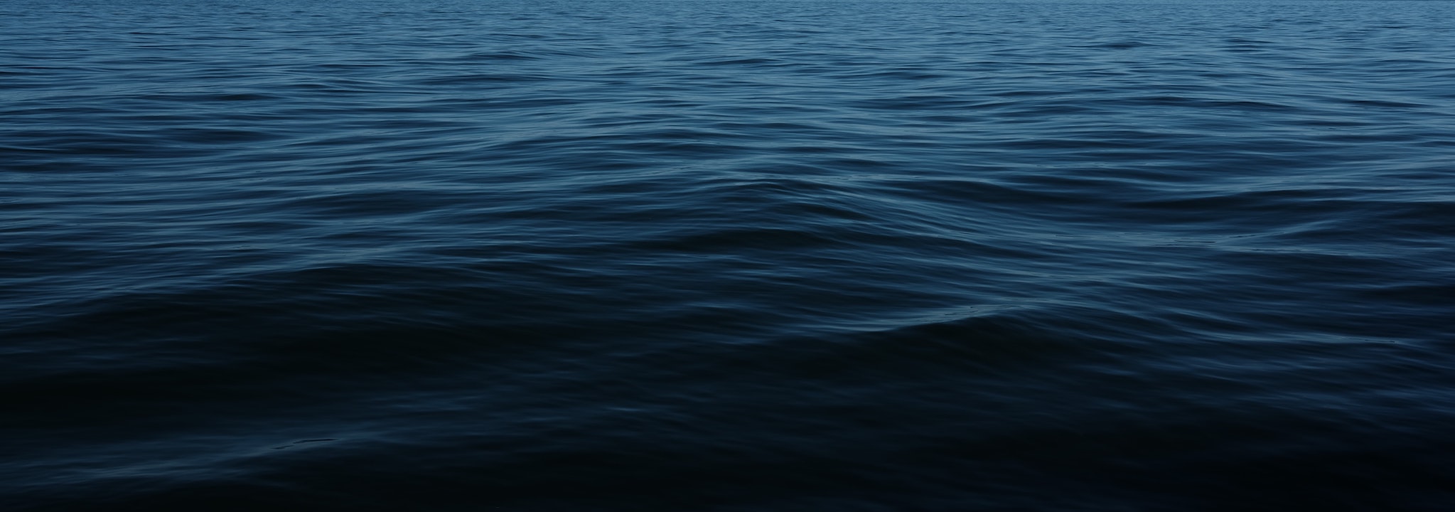 low angle perspective of large, dark body of water